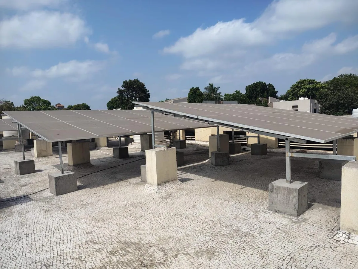 Wide completed solar installation with multiple raised panel rows and accessible rooftop spacing