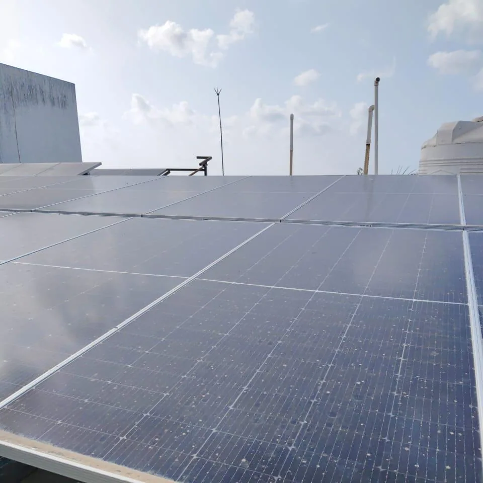 Close inspection view across a completed rooftop solar module field in Navsari
