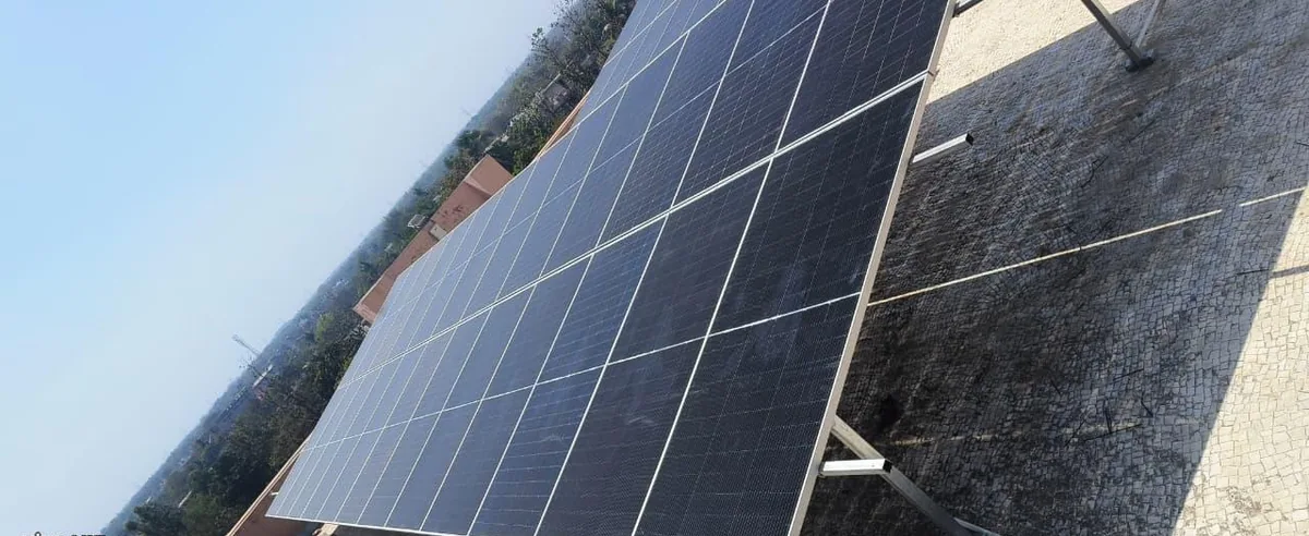Oblique close view across a completed rooftop solar panel array showing module alignment