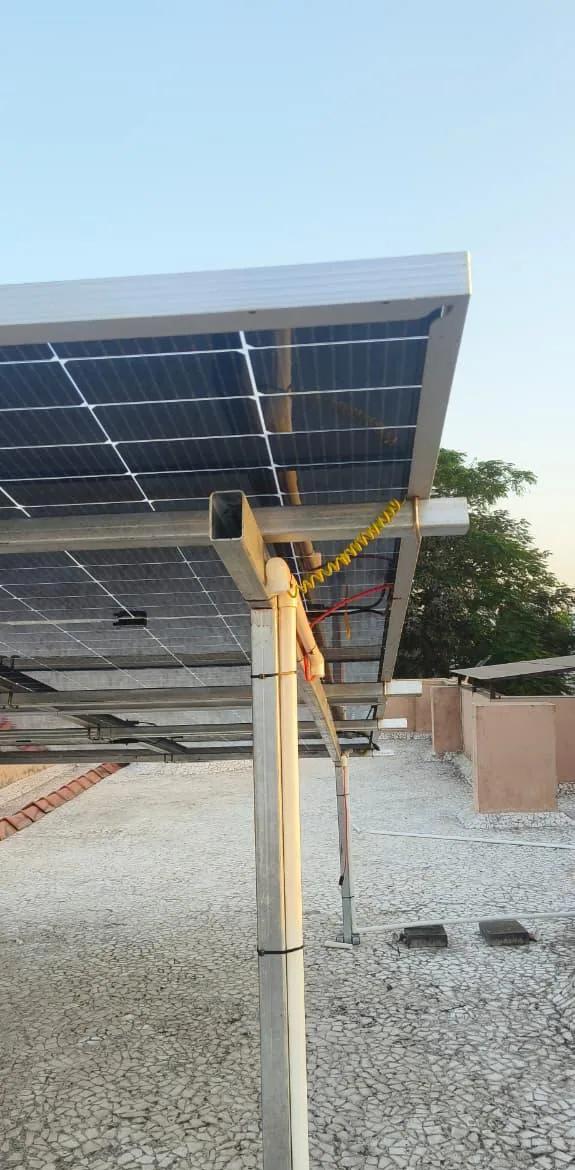 Vertical underside view of a solar array showing the steel column, wiring route and earthing conductor
