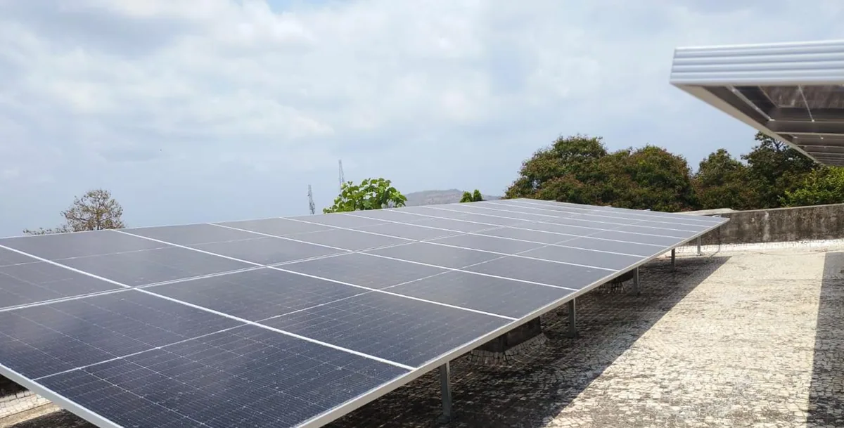 Completed rooftop solar array in Vansda with a maintenance path beside the panels